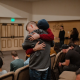 Two men hugging each other in a crowd.